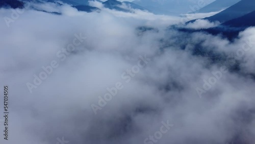 Areal drone footage from Karpenisi area, into the mountains and lake.