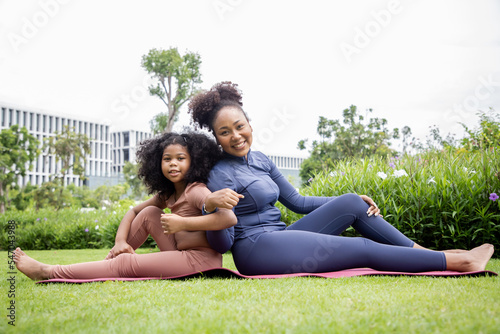 Yoga outdoor in the park. Young woman relax after doing yoga exercise outdoor at the day time with fresh air in the garden. Sport and exercise concept