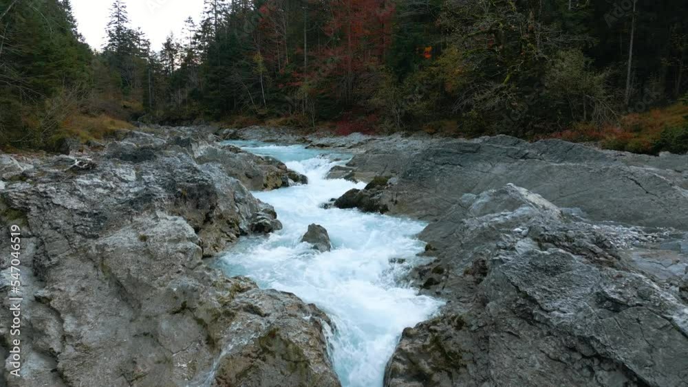 Mountain river waterfall canyon with fresh blue water in Bavaria Austria alps, flowing along a forest and trees near Sylvenstein Speicher and Walchensee. Aerial drone scenic slow motion idyllic 4K. Mountain river waterfall canyon with fresh blue water in Bavaria Austria alps, flowing along a forest and trees near Sylvenstein Speicher and Walchensee. Aerial drone scenic slow motion idyllic 4K.