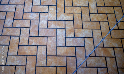 Yellow, Tan, and White Rectangular Tile Patters with a Silver Inset.