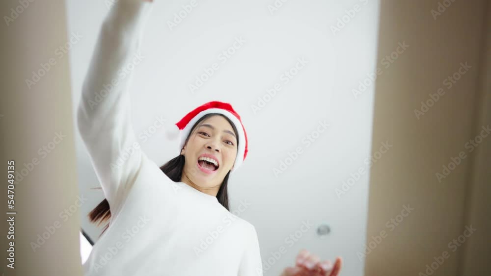 Happy young asian woman wearing christmas hat and unpacking gift box. Beautiful female smiling and surprised while opening present and looking inside. Happy new year, Merry christmas and Thankgiving Happy young asian woman wearing christmas hat and unpacking gift box. Beautiful female smiling and surprised while opening present and looking inside. Happy new year, Merry christmas and Thankgiving