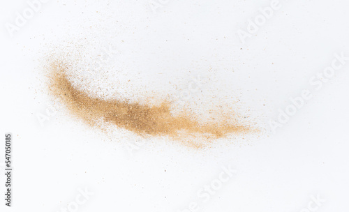 Sand flying explosion, Golden sand wave explode. Abstract sands cloud fly. Yellow colored sand splash throwing in Air. White background Isolated high speed shutter, throwing freeze stop motion
