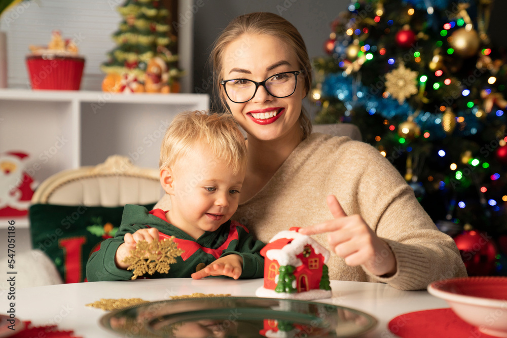 Christmas preparations. Mother and son at the table. Christmas preparations. Mother and son at the table.
