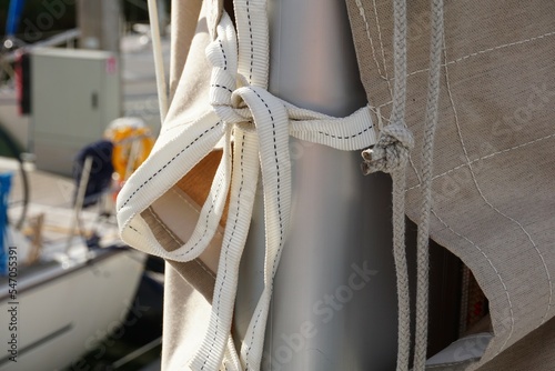 Bow on the cover that covers the mainsail of a sailboat and protects it from weather conditions. Cover for protection against UV radiation when lying still in the port. photo