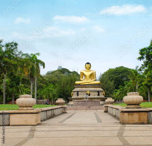 The Golden Buddha statue is located in Viharamahadevi Park, or Victoria Park, a public park located in Colombo, Sri Lanka. photo