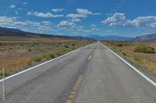 State Highway 90 passing Paradox Valley with La Sal mountains at the background (Montrose County, Colorado, USA)