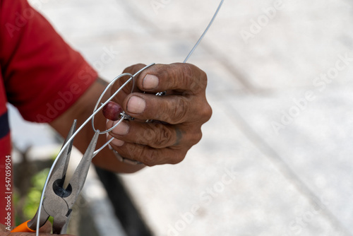 older man craftsman making metal figurines in the street, mexico latin america