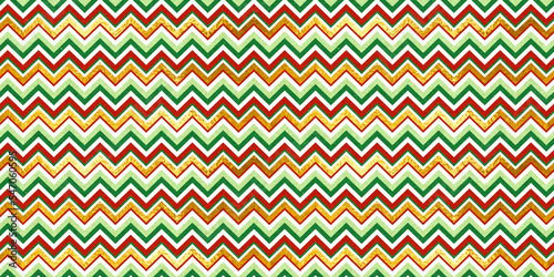Red and green vintage craft textured seamless chevron zigzag stripes Christmas pattern with shiny gold foil decoration. Retro herringbone xmas card background, winter holiday backdrop, wrapping paper.