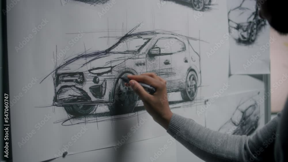 Automotive african american male designer drawing sketch blueprint with marker on whiteboard, developing new generation electric car design. He working in car design development modern studio.