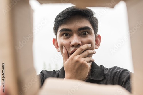 Billede på lærred A young woman opens up a box, disappointed and shocked to see their order worse than expected