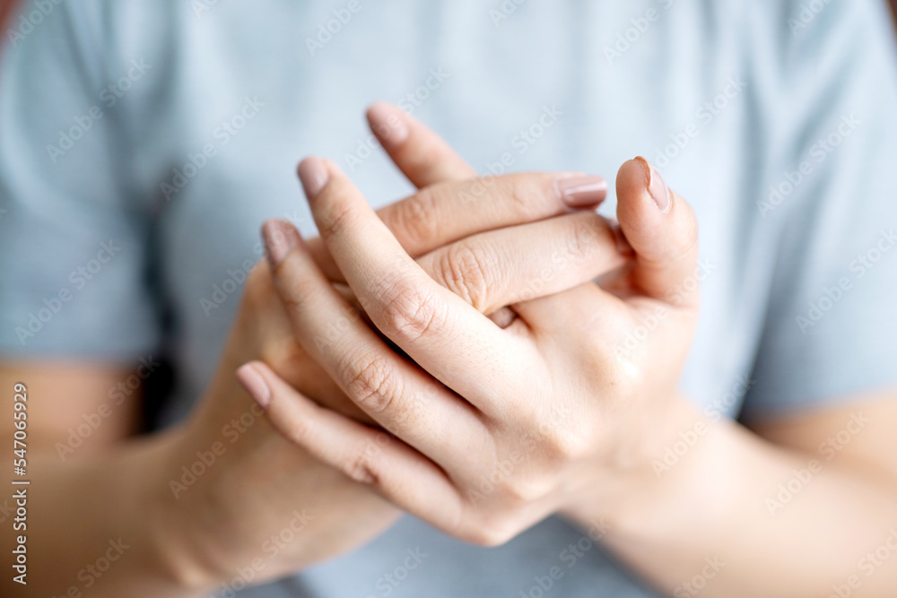Woman suffering from hand and finger joint pain. Causes of rheumatoid arthritis, carpal tunnel syndrome, gout. Health care and medical concept. Woman suffering from hand and finger joint pain. Causes of rheumatoid arthritis, carpal tunnel syndrome, gout. Health care and medical concept.