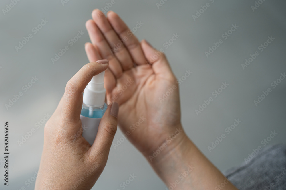Close up of asian woman use alcohol spray for hand hygiene, bacteria and virus protection concept. Close up of asian woman use alcohol spray for hand hygiene, bacteria and virus protection concept.