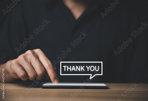 Man touches the smartphone and sends message words to thank you.