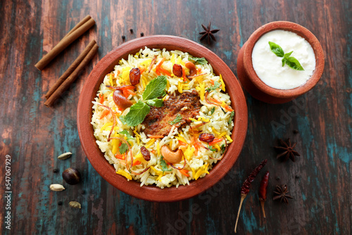 Chicken biryani Spicy Indian Malabar biryani Hyderabadi biryani, Dum Biriyani pulao golden bowl Kerala India Sri Lanka Pakistan basmati rice mixed rice dish with meat curry Ramadan Kareem, Eid photo