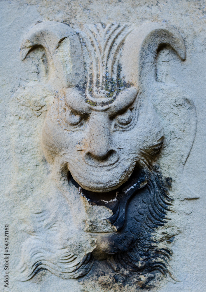 Old bas-relief of devil on the castle wall