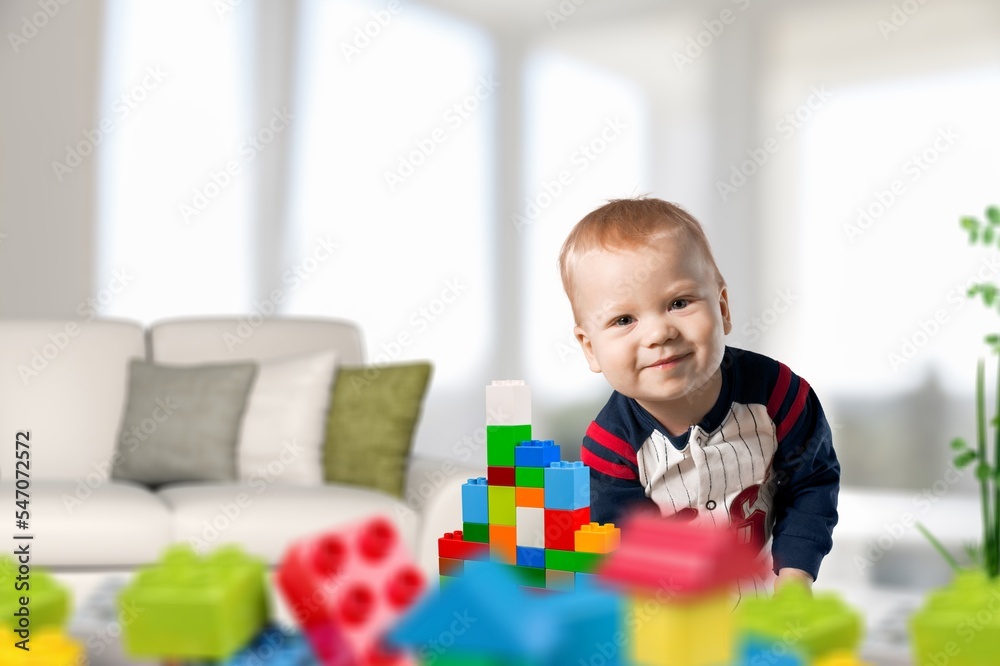 Cute child play with toys in room. Cute child play with toys in room.