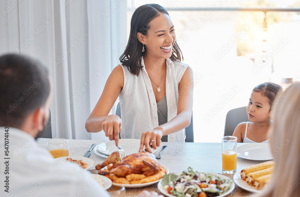 Chicken, happy and family lunch with woman cutting with knife, meal and food in dining room or celebration event. Love, happiness and group of people eating or laugh at brunch in family home together