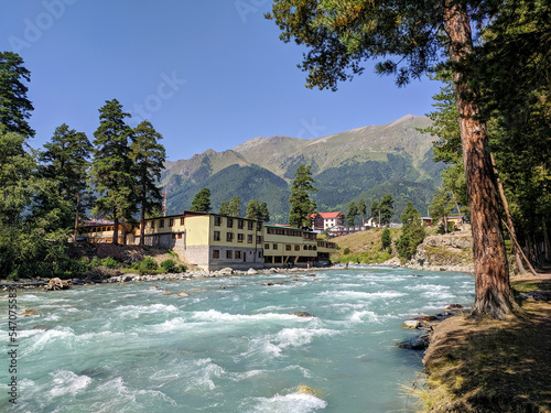 Arkhyz, Karachay-Cherkessia, Russia - August 26, 2022: View of the Zelenchuk River in the village of Arkhyz against the backdrop of the Caucasus Mountains