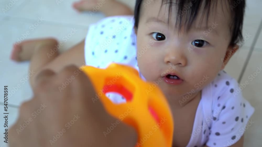 POV father's hand hold the rattle boy toy and play with baby POV father's hand hold the rattle boy toy and play with baby