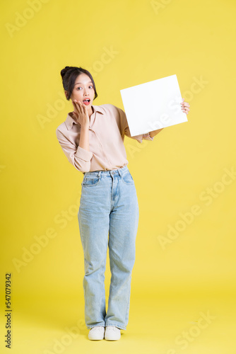 image of a pretty asian girl holding a white billboard