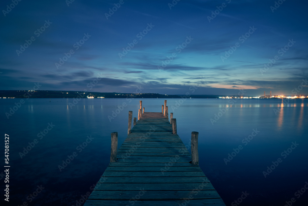 Landscape photo of a jetty on lake at night in Varna, Bulgaria. - obrazy, fototapety, plakaty 