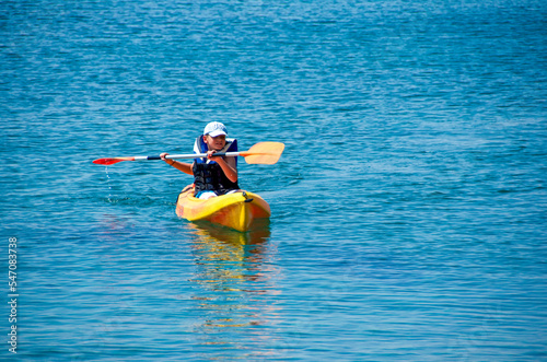 Boy with  life buoy suit in kayak lessons during summer vacations in Greece