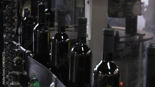 Industrial wine bottling plant machine. Modern industry production line for wine bottling and packaging
