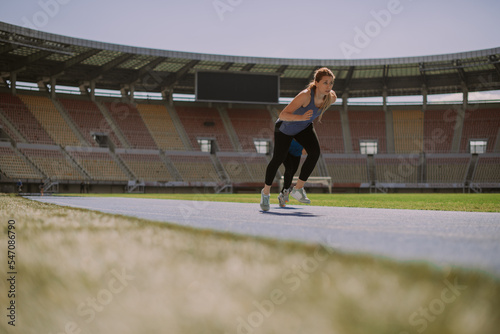 Beautiful girls running on a sports track at the stadium