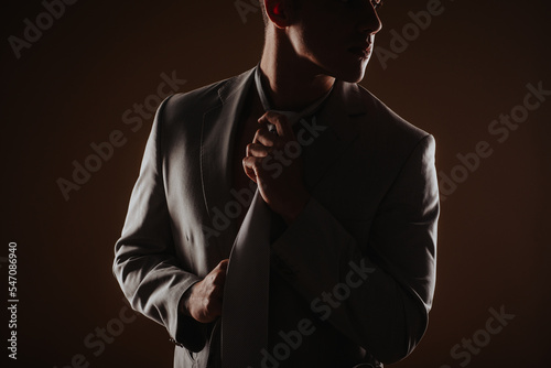 Close up of man fixing his tie
