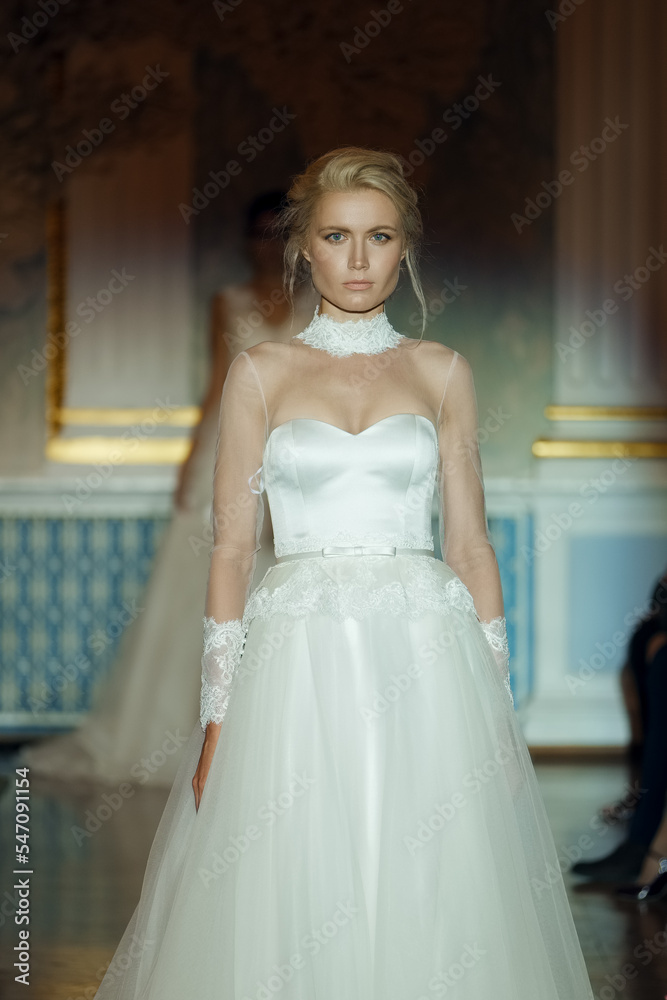 Fototapeta premium Attractive fashion model on stage in spotlight. Wedding makeup and hair style.