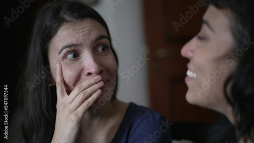 Woman reacting with surprise and unbelief to news told by friend. Person closeup face emotional reaction with consternation