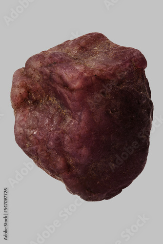 Close up still life dark red Zambian ruby on gray background
