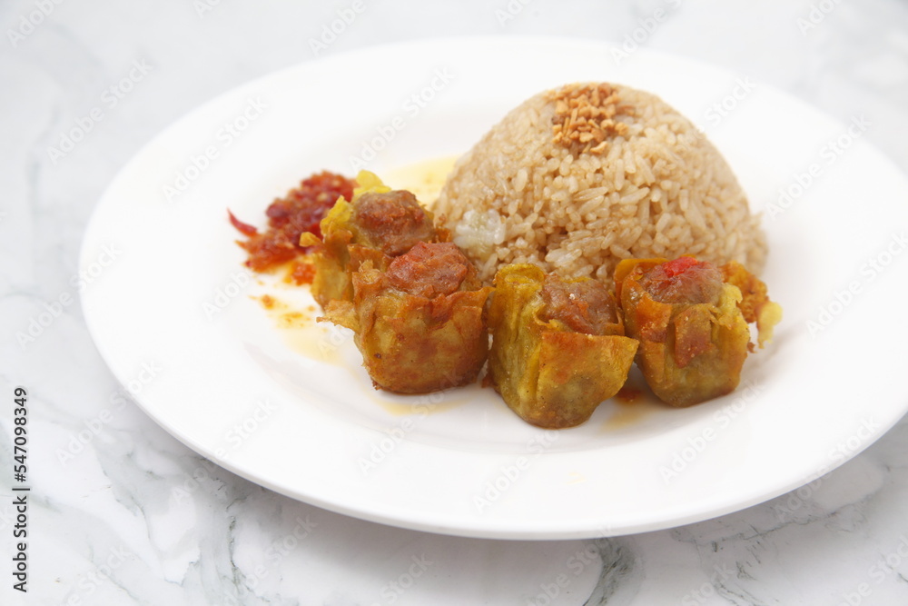 Freshly cooked Filipino food called Budbod rice with fried pork siomai