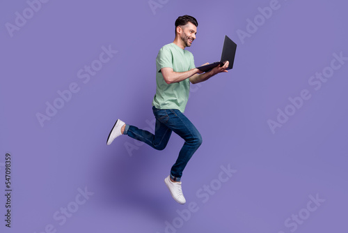 Full length photo of satisfied stylish man worker enjoy using new gadget device speed fast connection isolated on purple color background
