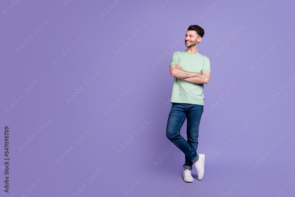 Full size photo of handsome young guy crossed arms look empty copyspace wear trendy gray clothes isolated on violet color background