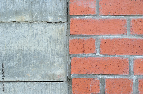 Close Up of Wall with Joint between Bricks and Concrete Blocks 