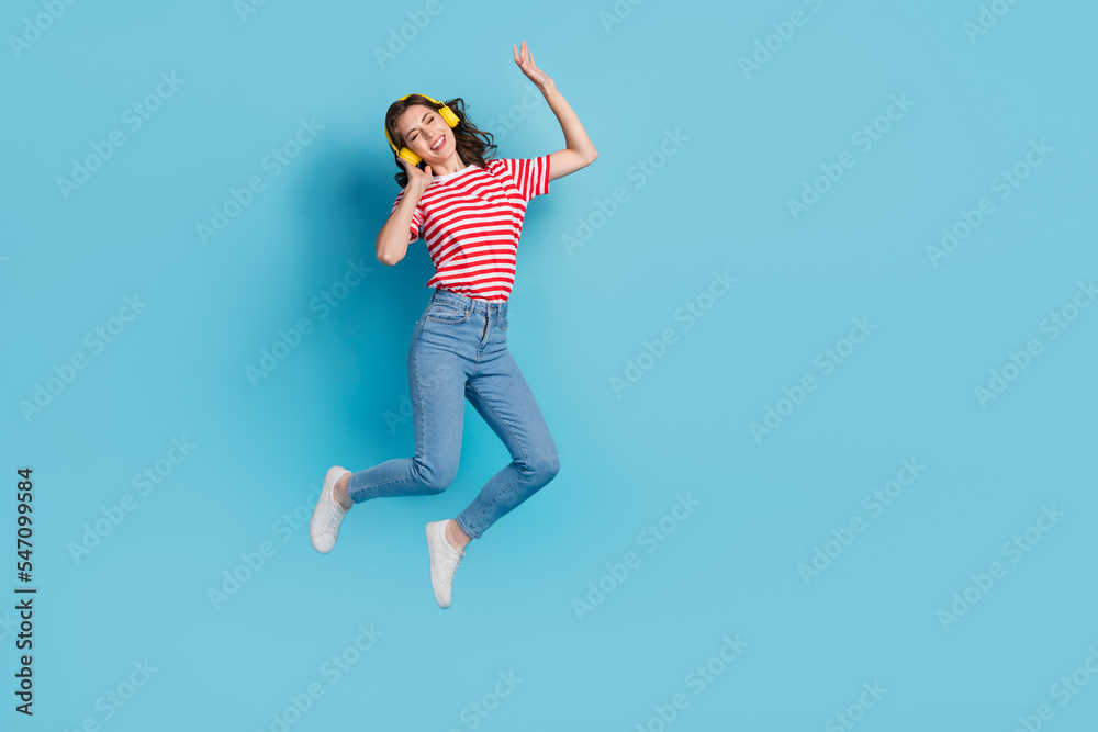 Full length photo of cheerful cool lady earbuds listen favorite singer melody quality sound empty space isolated on blue color background