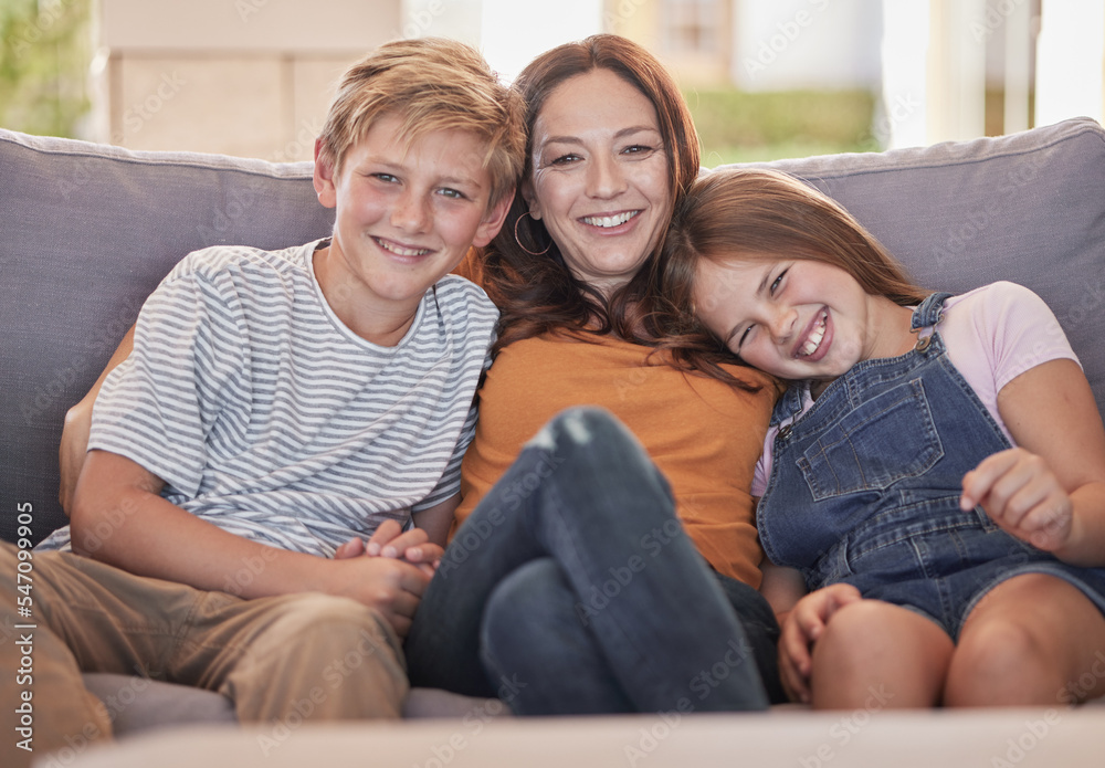 Portrait of mom, children relax and smile on sofa together bonding, love and care in living room at family home. Boy kid, girl child and a happy mother hug kids on couch in lounge with young siblings