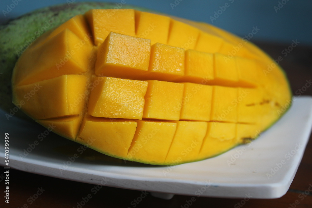 ripe mangoes sliced ​​in squares on a plate
