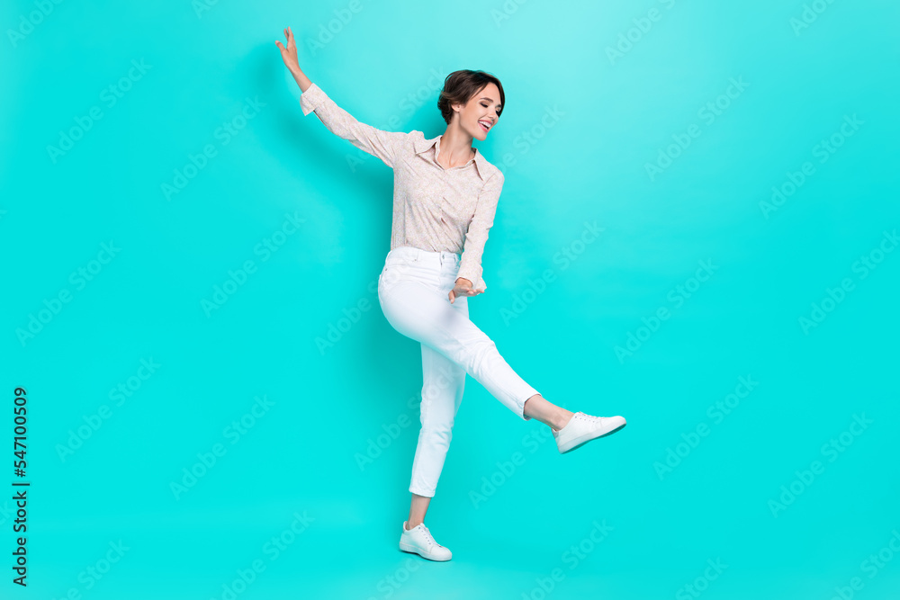Full length photo of adorable dreamy shiny woman lady wear stylish clothes dance hobby relax rest time isolated on cyan color background Full length photo of adorable dreamy shiny woman lady wear stylish clothes dance hobby relax rest time isolated on cyan color background