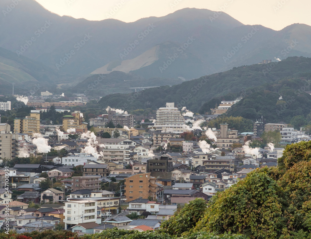 Beppu cityscape with Steam rised from public baths and onsen (hot spring). Beppu is one of the most famous hot spring resorts in Oita, Kyushu, Japan.