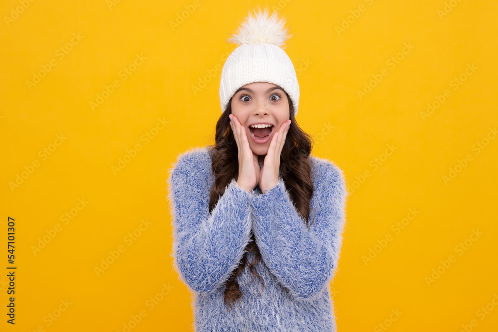 Modern teen girl wearing sweater and knitted hat on isolated yellow background. Excited face, cheerful emotions of teenager girl. Modern teen girl wearing sweater and knitted hat on isolated yellow background. Excited face, cheerful emotions of teenager girl.