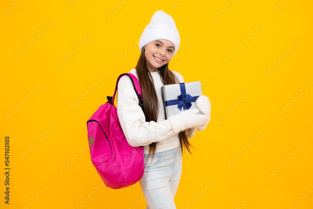 Teenager child holding gift box on yellow isolated background. Gift for kids birthday. Christmas or New Year present box. Teenager child holding gift box on yellow isolated background. Gift for kids birthday. Christmas or New Year present box.
