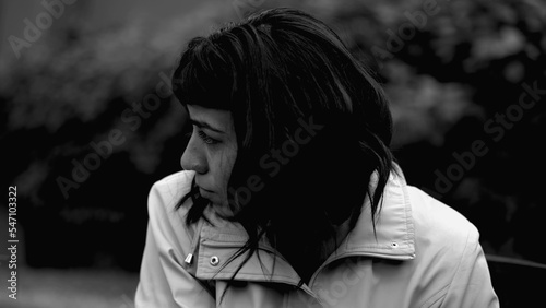 A depressed latin woman having the support of friend. Two women hugging each other in monochromatic. Sad person closeup face