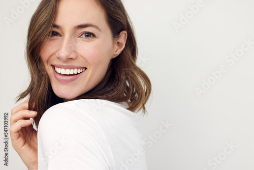 closeup portrait of young happy woman looks in camera photo