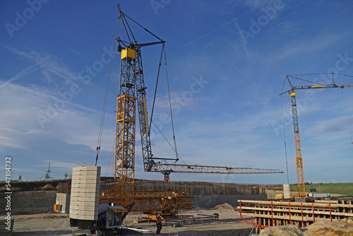 Folding crane mounting on a bridge construction site for the overpass of a service road over the future A143 motorway photo