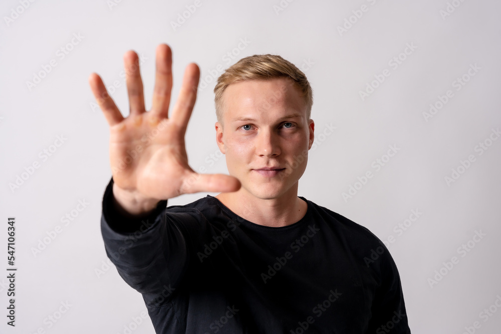 Attractive blonde german model in a black jersey on a white background, stop racism, stop homophobia Attractive blonde german model in a black jersey on a white background, stop racism, stop homophobia