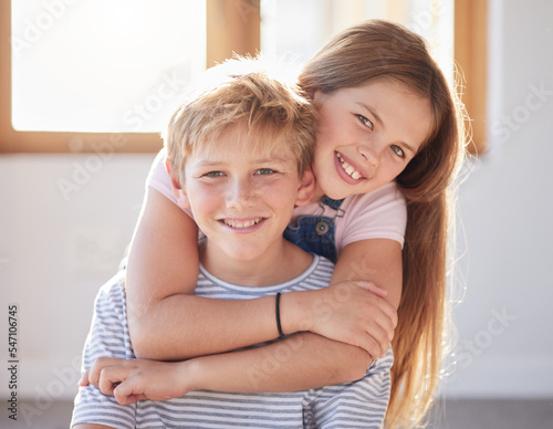 Family, hug and portrait of girl an boy in a living room, bonding and happy while enjoying quality time together. Face, happy family and sibling brother and sister embrace, playful and relax at home photo