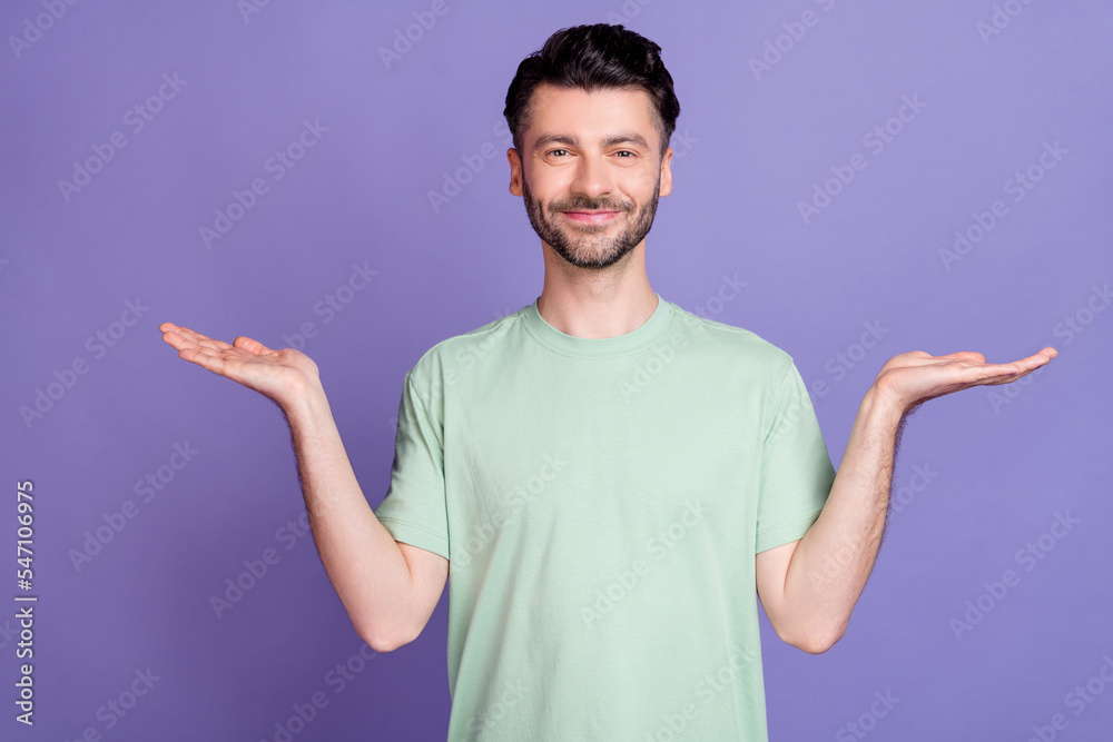Photo of positive cool man dressed stylish clothes two arm hold empty space vs scales compare price isolated on purple color background