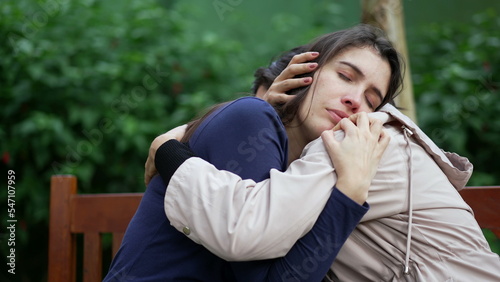 Fotografija Supportive friend consoling suffering girl at park bench